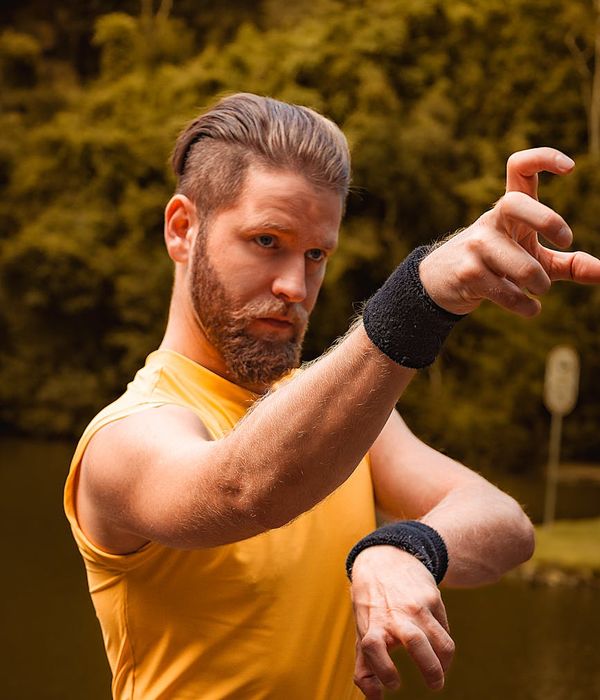 Man performing a focused strength exercise in a calm environment.
